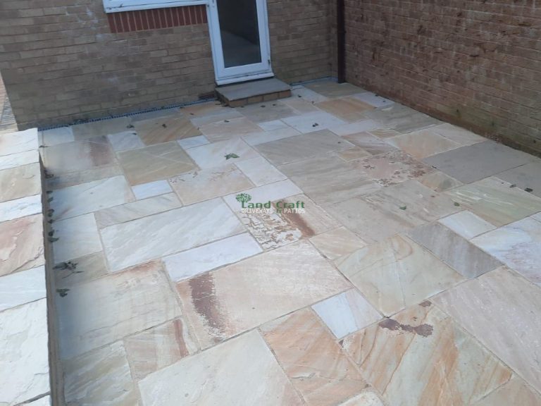 Natural Indian Sandstone Slabbed Patio with Brick Wall in Crawley